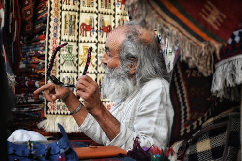 Elderly Man Sitting with Sunglasses