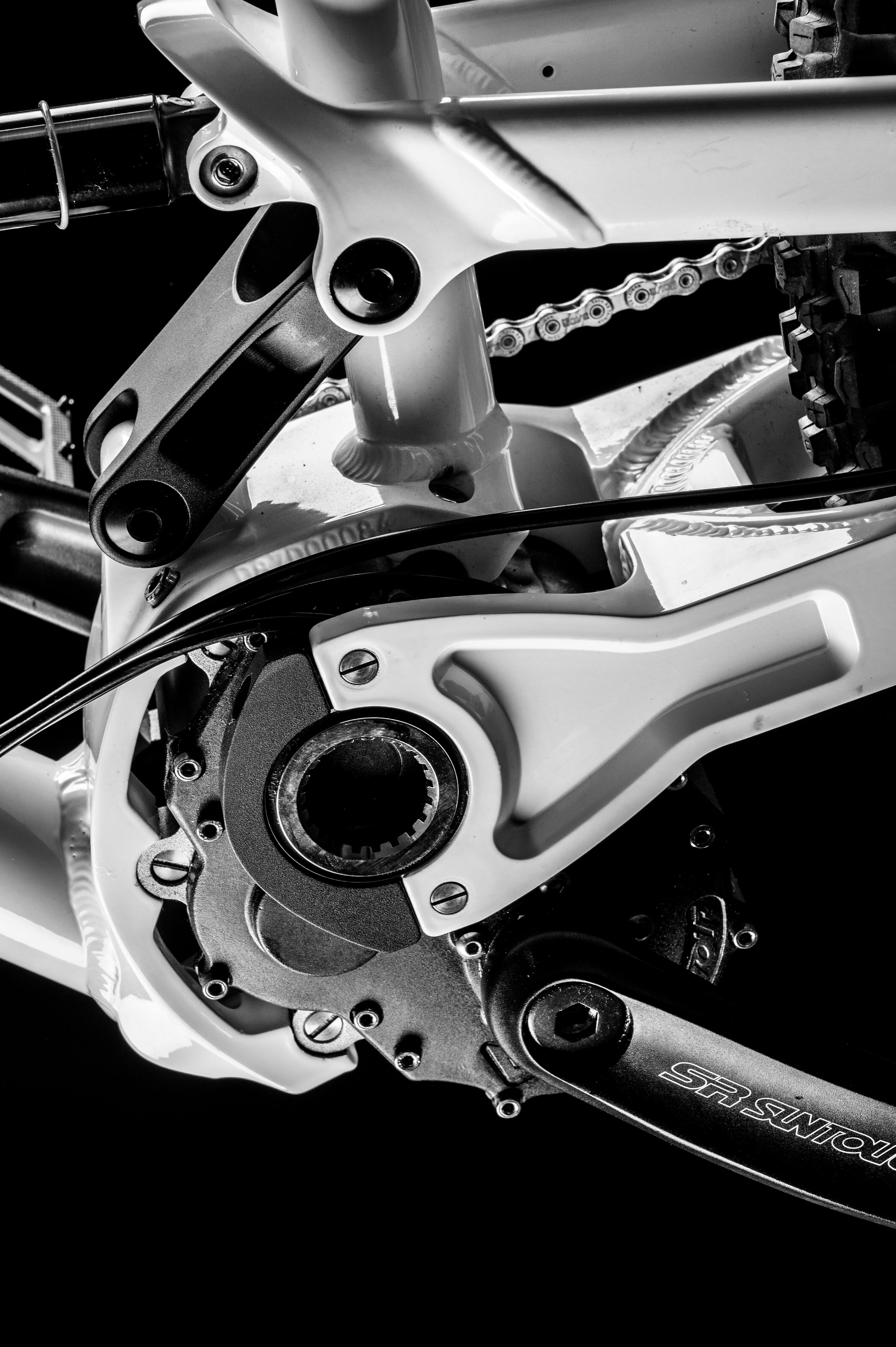 Detailed black and white shot of a bike's gear mechanism showcasing its engineering.