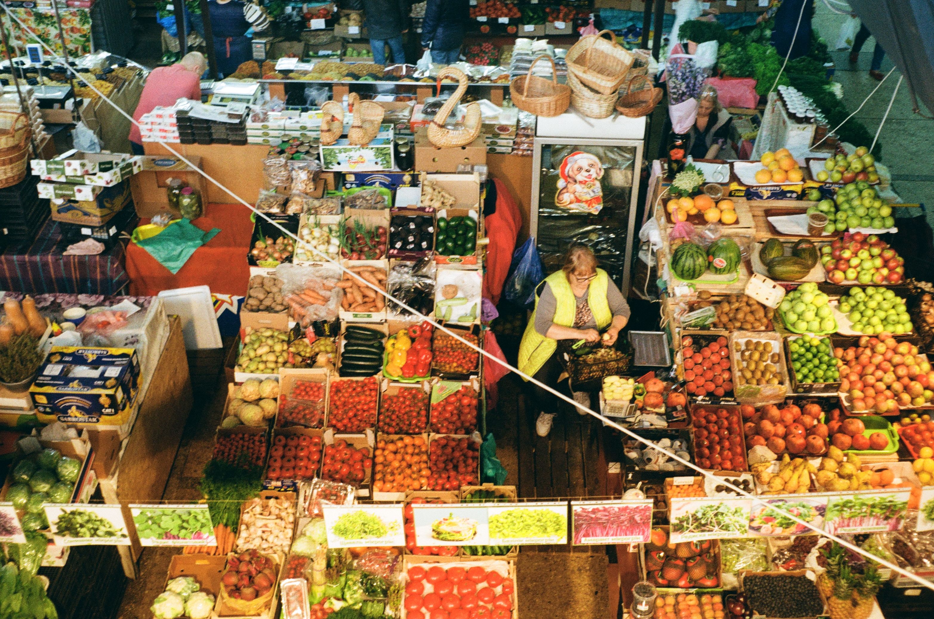 Aerial view of a bustling market in Kyiv with diverse fruits and vegetables on display.