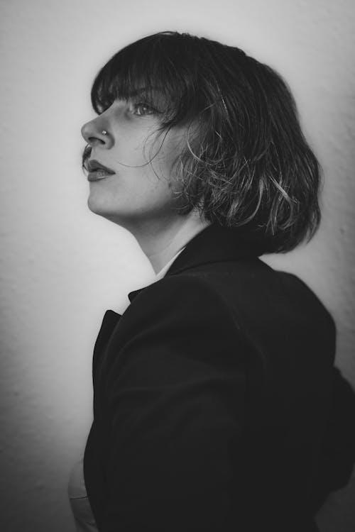 Free A Grayscale Photo of a Woman in Black Blazer with Nose Piercing Stock Photo