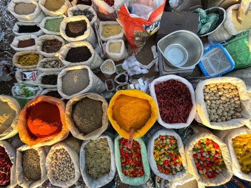 Free Top view of a vibrant assortment of spices in sacks at a market, displaying the colorful variety of ingredients. Stock Photo