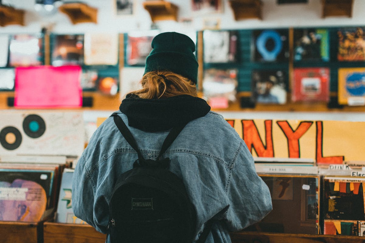 Person browsing vinyl records in a record shop
