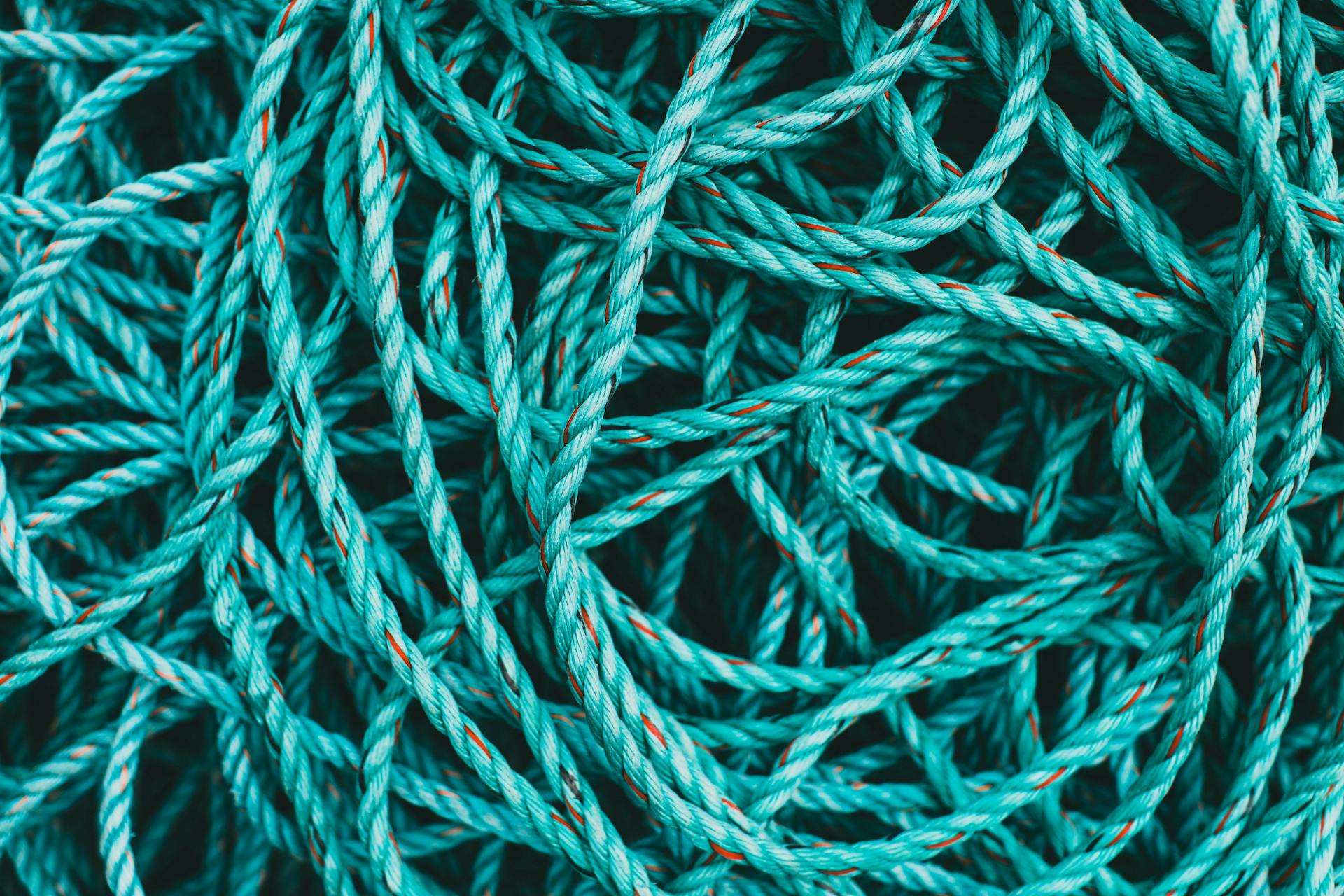 Artistic close-up of tangled blue nylon ropes highlighting texture and color contrast.