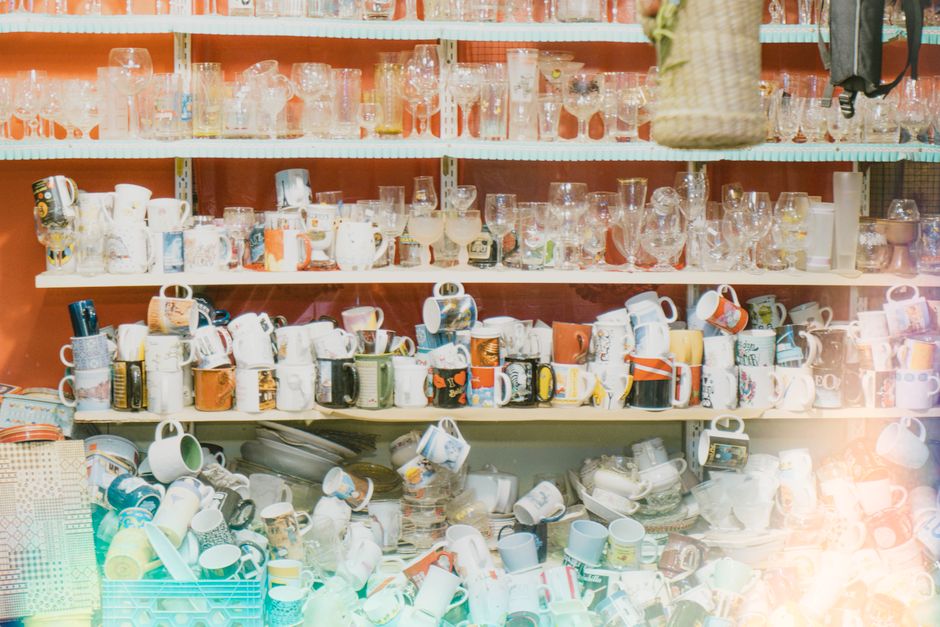 overwhelmed person surrounded by too many shopping items clutter