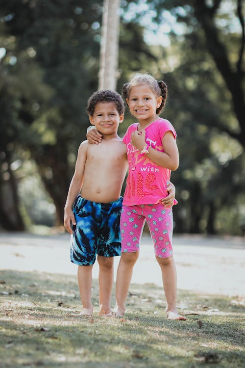 Shirtless Boy Standing Beside a Girl