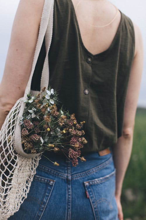 Woman with Flowers in Bag