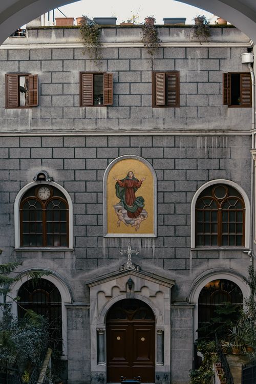 Free Exterior view of a church with a religious mosaic, showcasing architectural details. Stock Photo