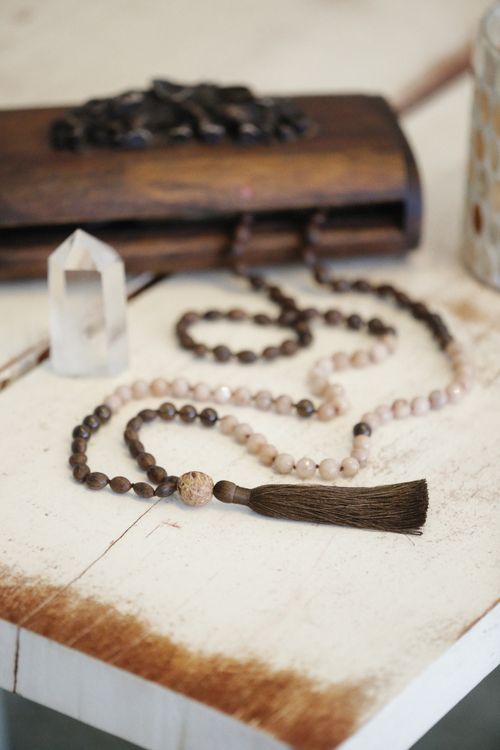 Free Close-up of prayer beads with crystal and wooden box, evoking spirituality and calm. Stock Photo