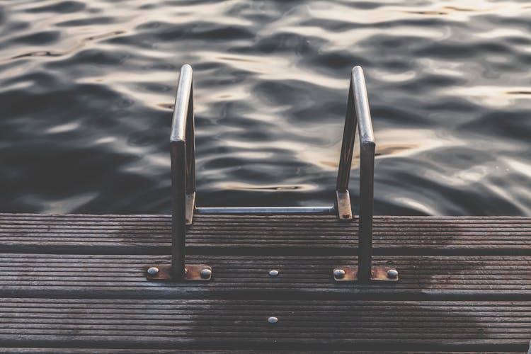 Gray Steel Dock Ladder Beside Body Of Water