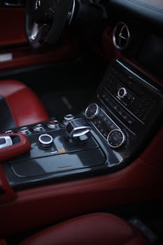 A sleek and modern car interior showcasing its luxurious controls and leather finish.