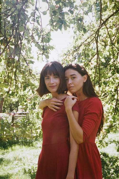 Woman Standing Behind Another Woman