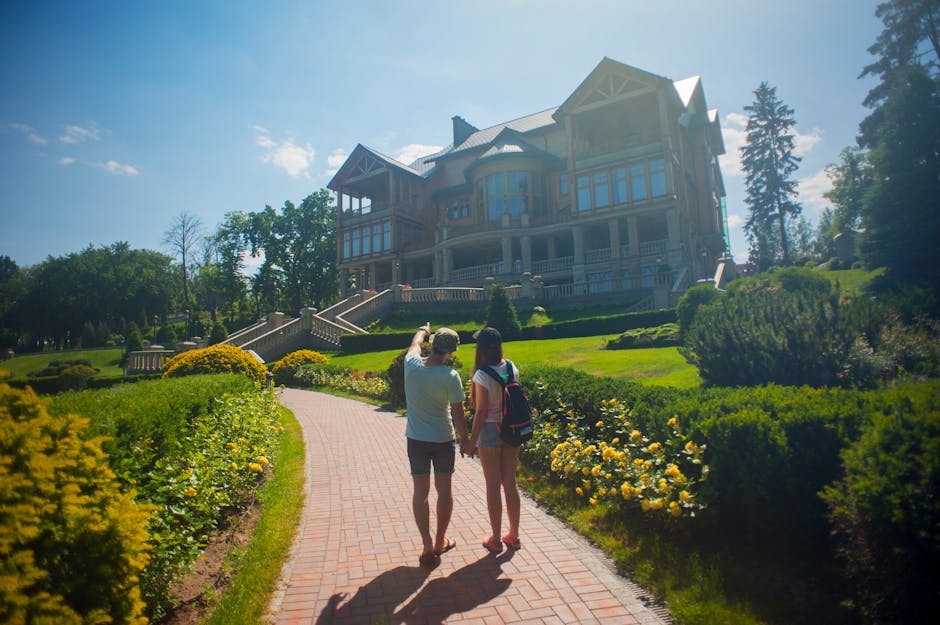 Photo of Couple Standing Outside the House