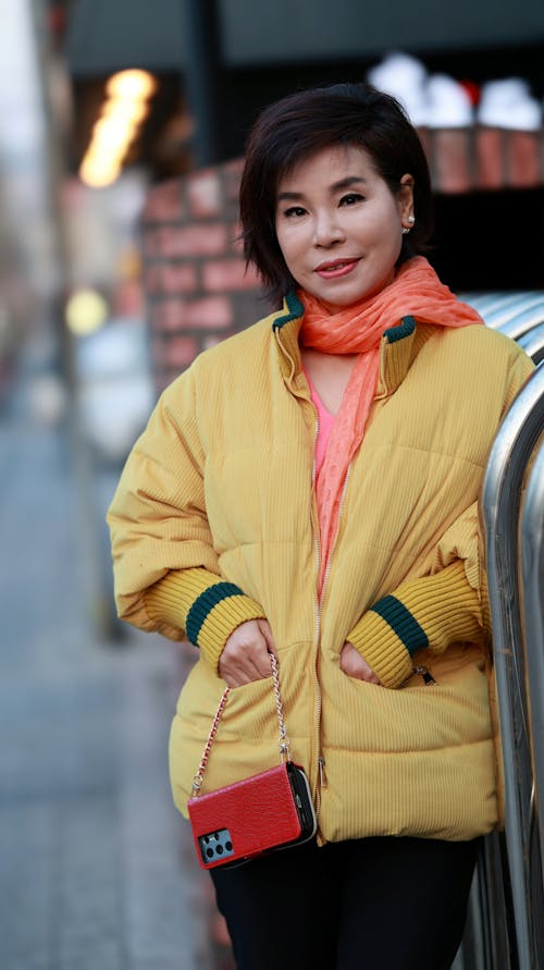 Woman in Yellow Jacket with Her Hands Inside the Pockets