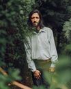 Woman in White Dress Shirt Standing Near Green Plants