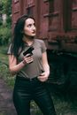 caucasian girl hold a gun. military girl. green t-shirt.
