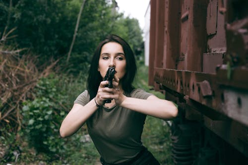 Free A Woman Holding a Gun Stock Photo