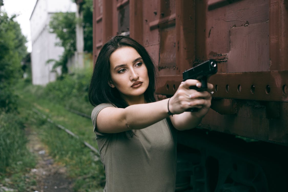 Free Woman Pointing a Gun Stock Photo
