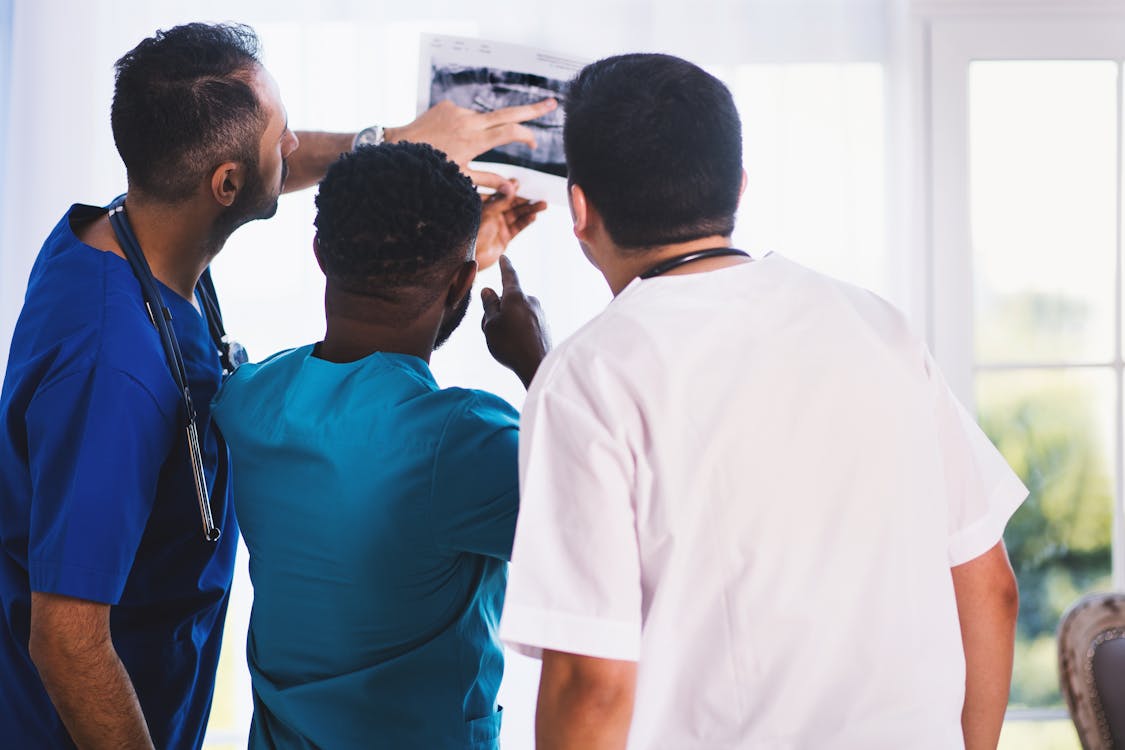 Three doctors looking an an X-ray