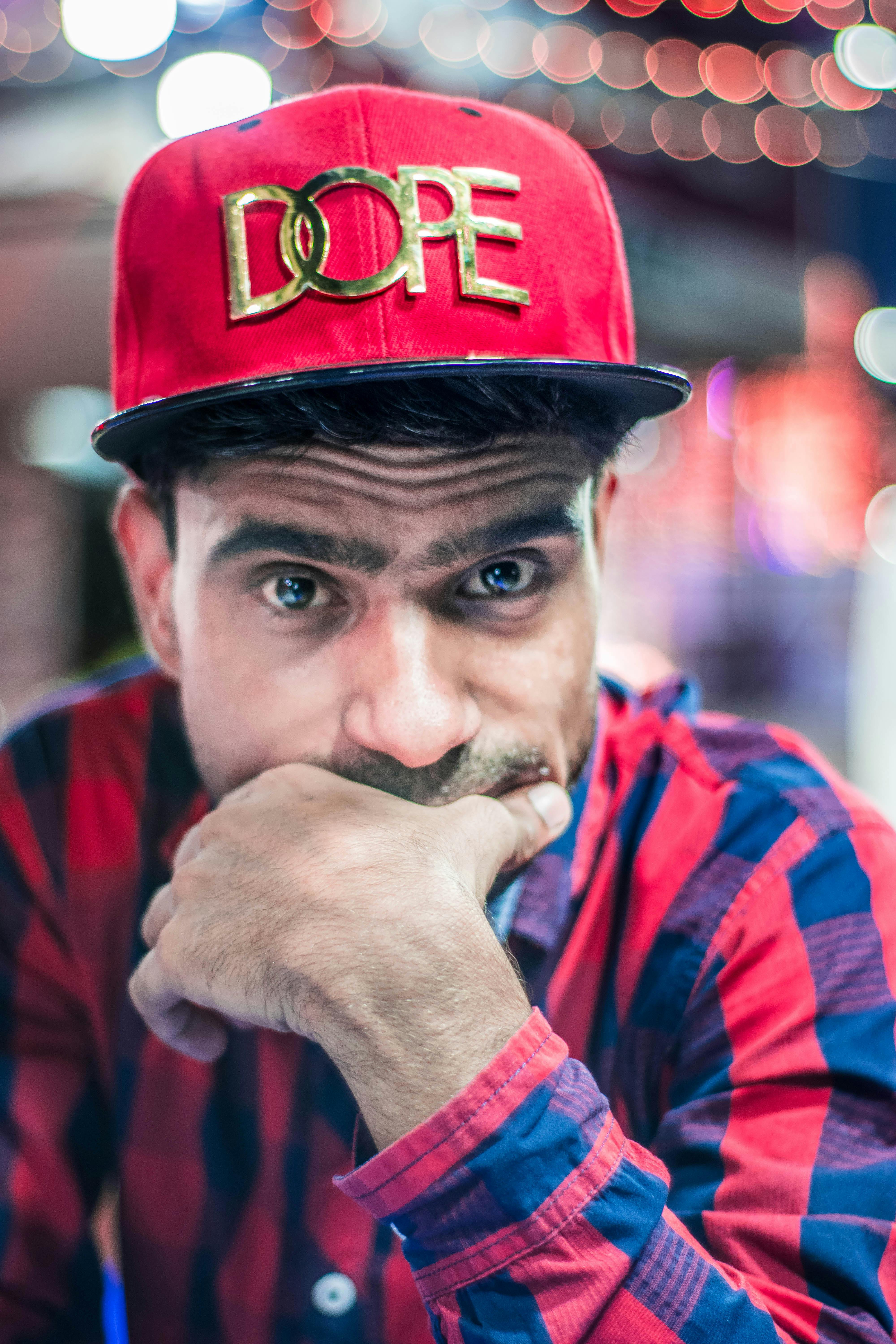 Photo of Man Wearing Plaid Shirt With Hand Near Face