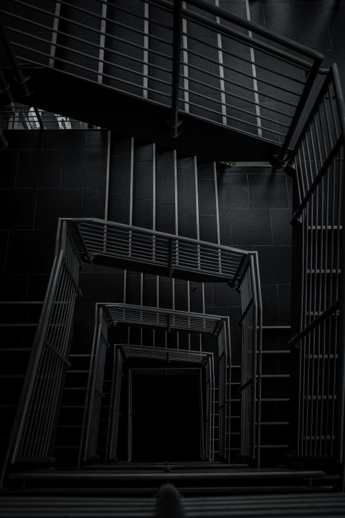 Free A breathtaking high-angle view of a monochrome spiral staircase indoors. Stock Photo