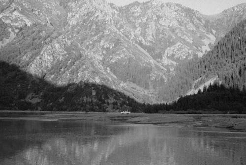 Grayscale Photo of Lake and Mountains