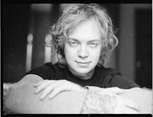 Black and White Photo of a Man with Long Hair