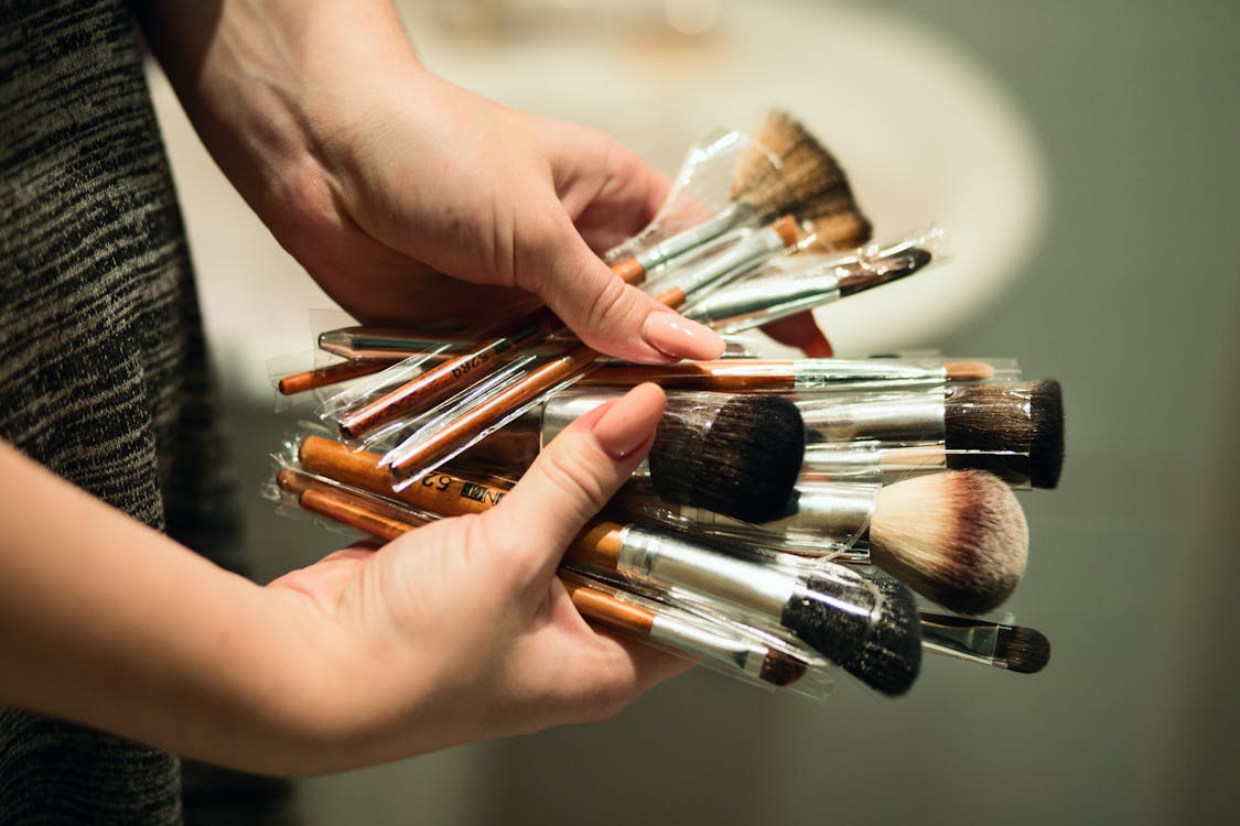 Free Person Holding Makeup Brushes Stock Photo