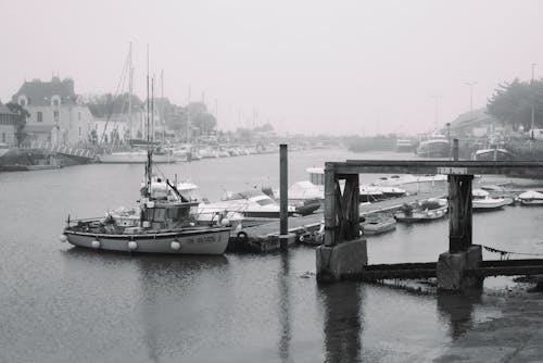 Grayscale Photography of Boats Docked on a River