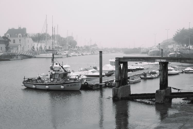 Grayscale Photography Of Boats Docked On A River