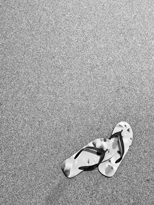 Grayscale Photo of Slippers