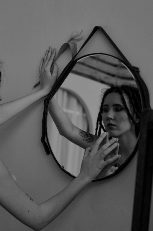 Woman Touching Her Reflection in Mirror · Free Stock Photo