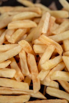 Close-up view of crispy golden french fries showcasing texture and deliciousness.