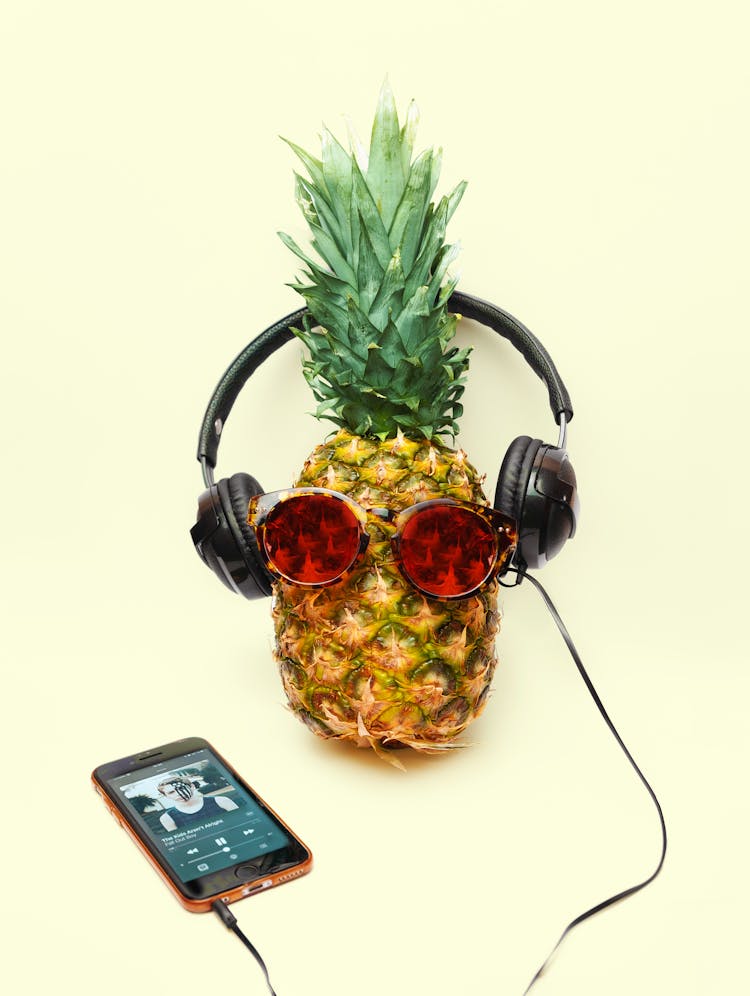 Funny Pineapple With Sunglasses And Headphones Connected On Iphone