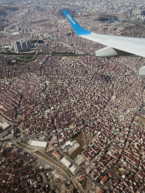 An Airplane Flying above a City