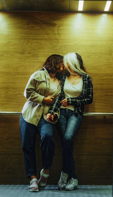 Women Kissing in Dimly Lit Room · Free Stock Photo