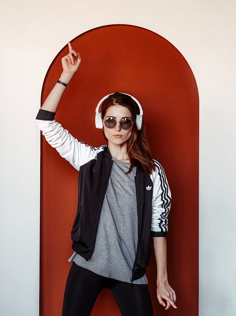 Woman Listening To Music With Hand In Air