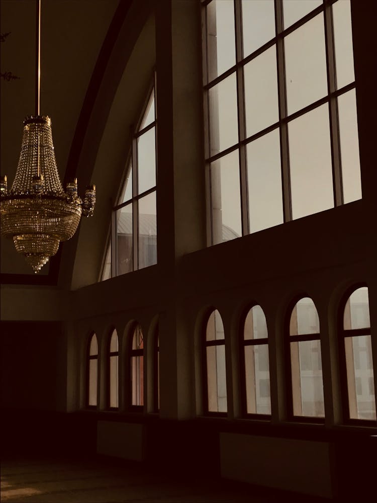 A Hanging Chandelier Near Glass Window