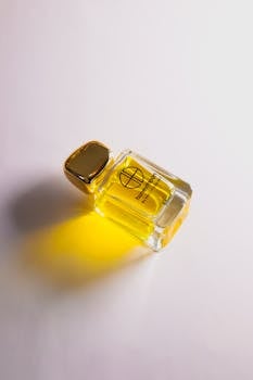 Stylish perfume bottle casting a bright yellow glow, perfect for luxury advertising.