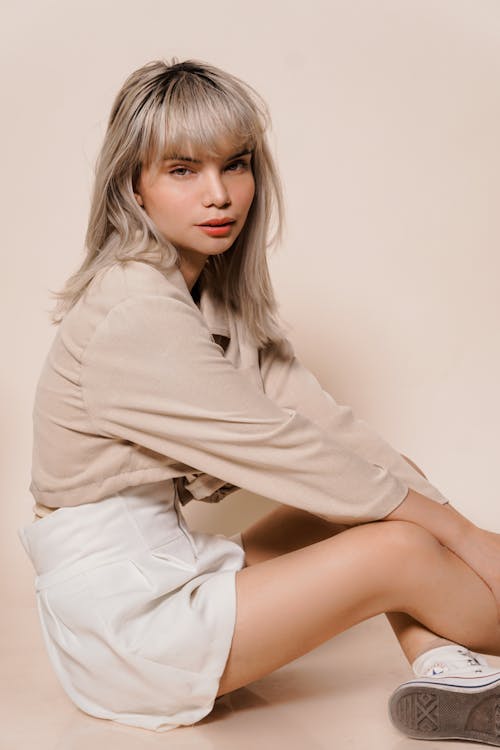 Woman in White Skirt Sitting on Floor