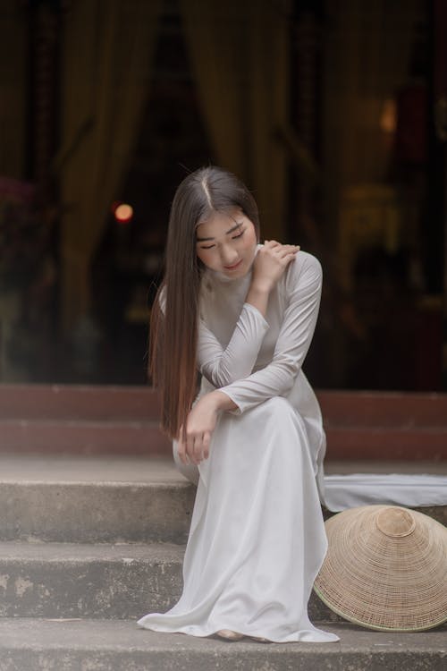 Selective Focus of a Woman Sitting on Concrete Stairs