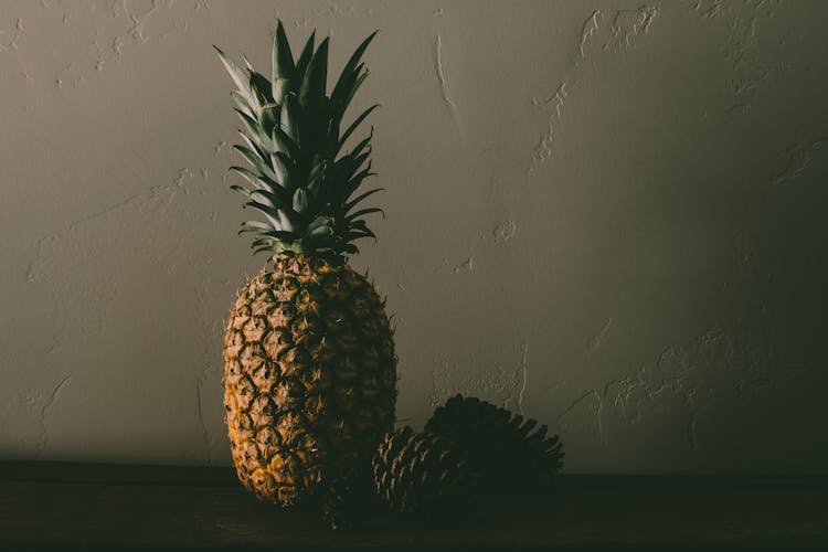 Pineapple Fruit Near Pine Cones