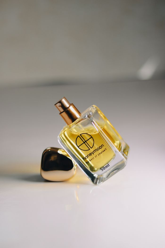 Luxury perfume bottle with golden accents on a minimalist background