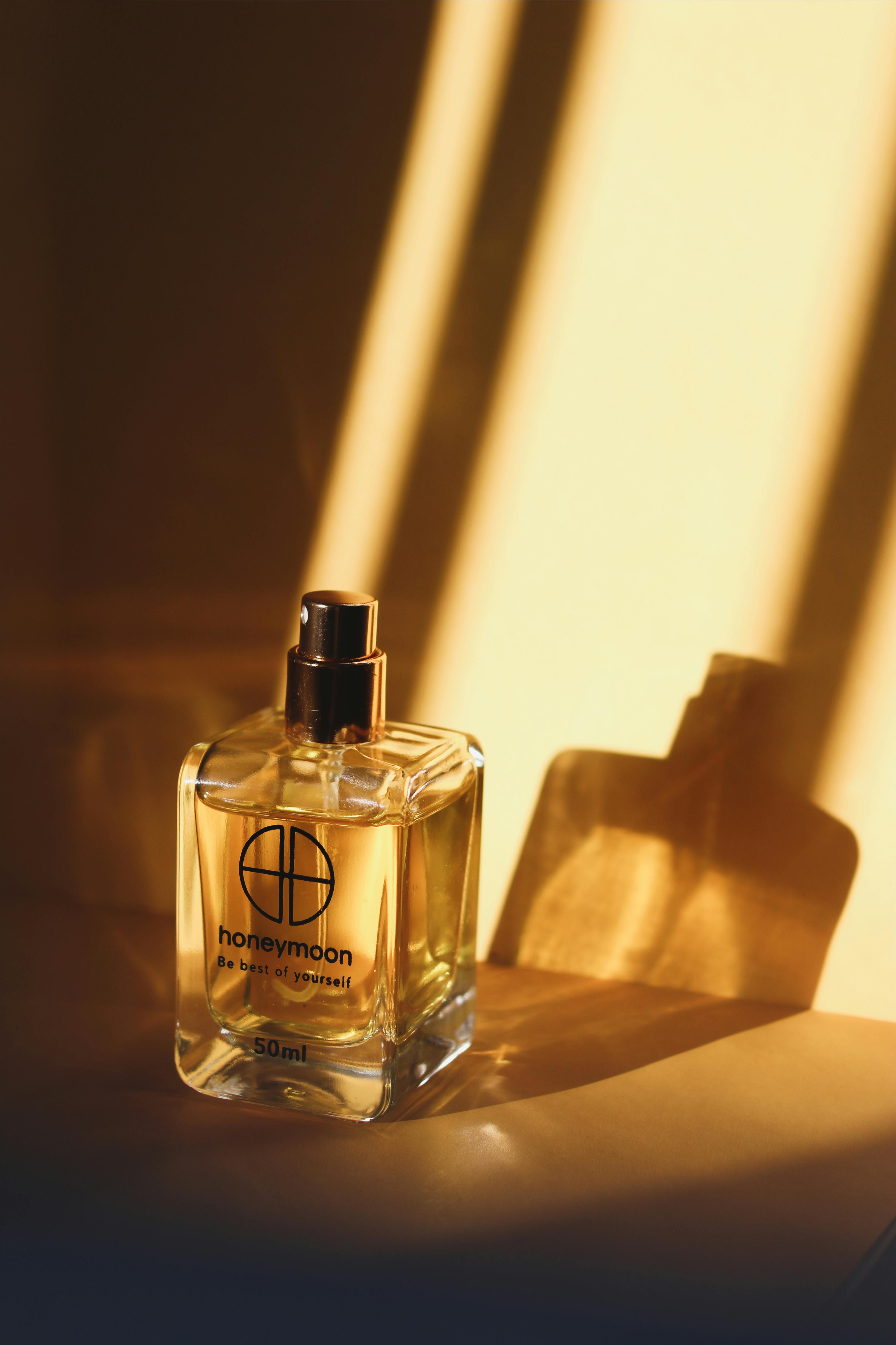 Bottled Perfume on White Surface · Free Stock Photo