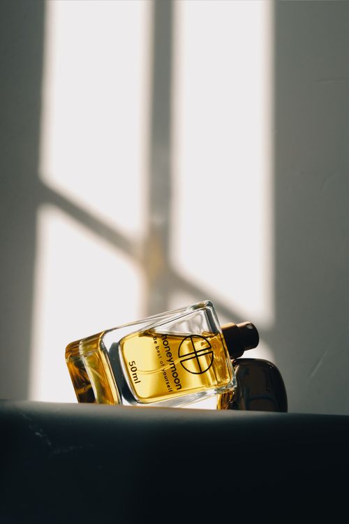 Free Sophisticated perfume bottle casting shadows in sunlight, ideal for product photography. Stock Photo