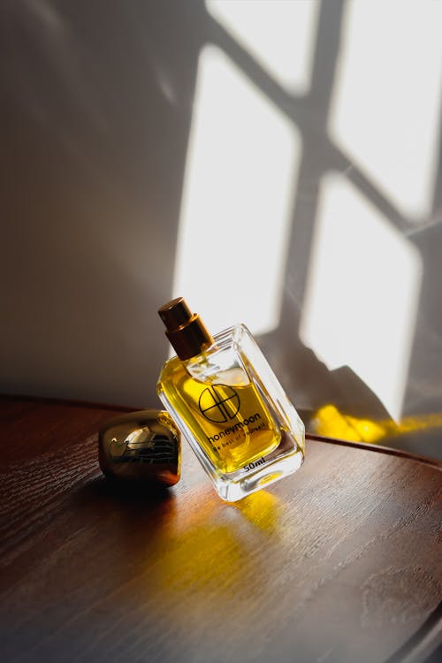 Free Clear Glass Perfume Bottle on Wooden Table Stock Photo