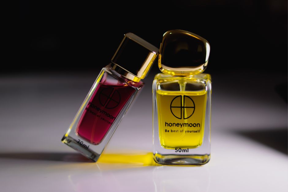 Close-up product shot of honeymoon perfumes in a studio setting.