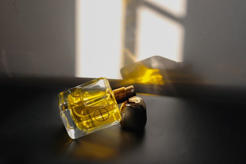 Free Perfume Bottle on Black Surface Stock Photo
