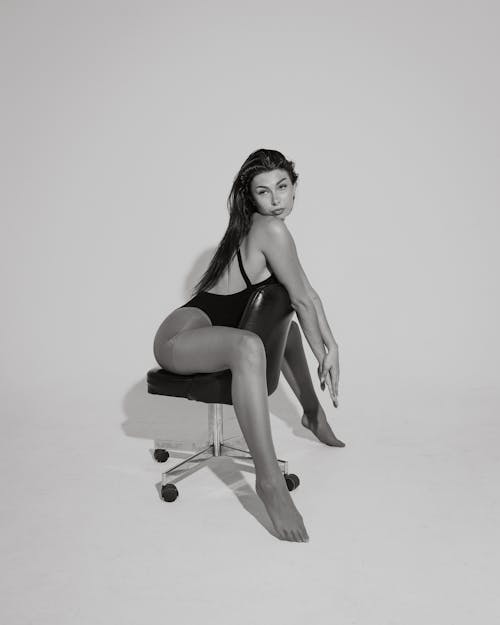 Woman in Swimming Costume Sitting on a Chair Backwards