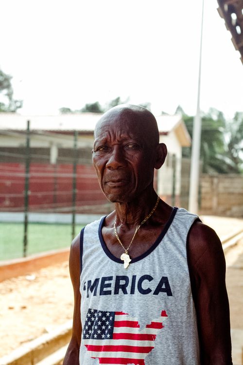 Free Close-up photo of a senior man outdoors wearing an American-themed sleeveless shirt and necklace. Stock Photo