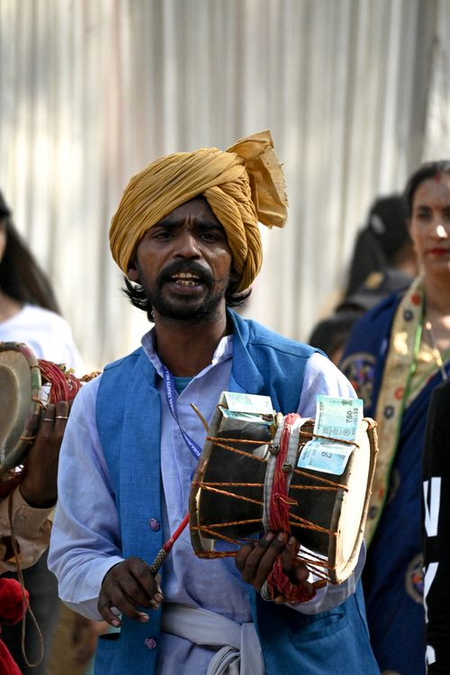 Free A man in traditional attire plays the drum during an outdoor festival in Faridabad, India. Stock Photo